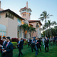 Members of the U.S. and Japanese media walk across the grounds of President Donald Trump’s Mar-a-Lago club during a visit by Japanese Prime Minister Shinzo Abe and his wife, Akie Abe, on April 18, 2018, in Palm Beach, Fla.